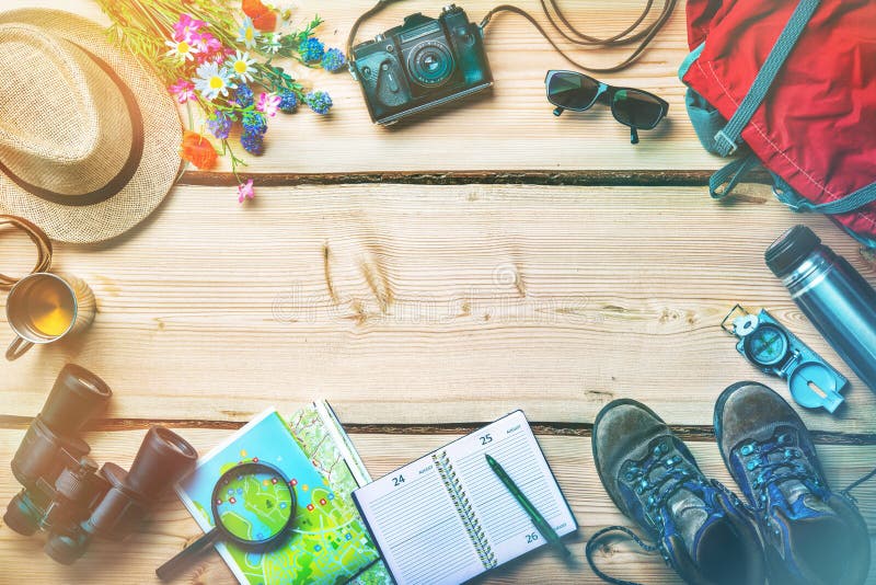 Overhead view of cycling route planning materials on wooden table